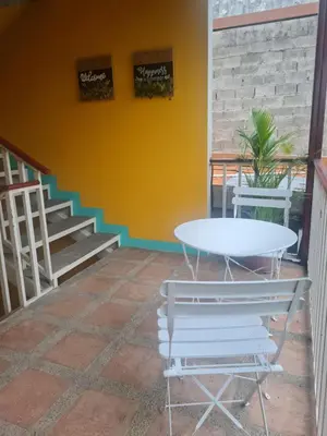 a table and chairs on a patio with a staircase at Hotel Liberia in Liberia