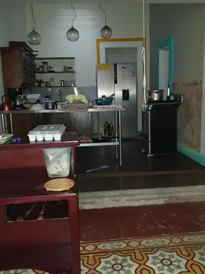 a large kitchen with a counter and a stove at Hotel Liberia in Liberia