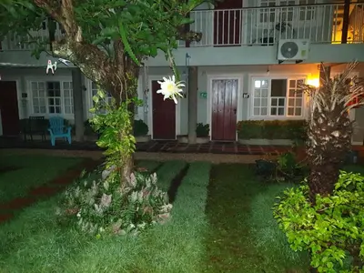 a house with a tree in the yard at Hotel Liberia in Liberia