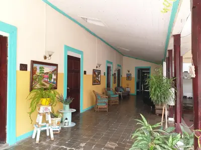a room with colorful walls and chairs and plants at Hotel Liberia in Liberia