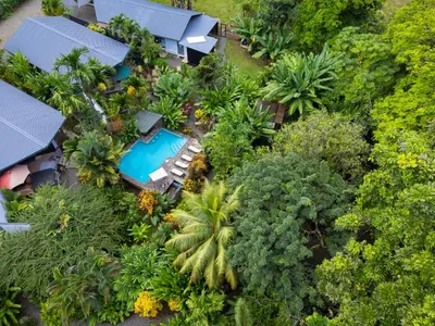 an aerial view of a resort with a swimming pool and trees at Bukala Village Lodge in San Ramón