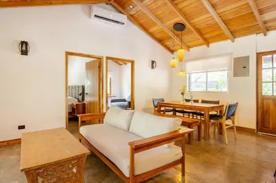 a living room with a couch and a table at Casa PlayaAzul, walk to the beach, 3 rooms in Santa Teresa Beach