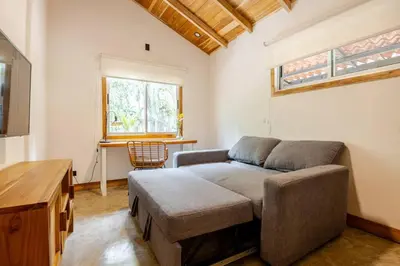 a living room with a couch and a table at Casa PlayaAzul, walk to the beach, 3 rooms in Santa Teresa Beach