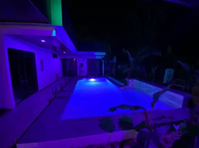 a swimming pool with purple lights in a house at Fortuna Jungle & River Retreat - Private pool, River and Wifi in the forest - Secluded, peaceful, truly UNIQUE! A GEM! Book Now! in Guayabal