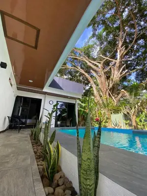 a house with some plants in front of a swimming pool at Fortuna Jungle & River Retreat - Private pool, River and Wifi in the forest - Secluded, peaceful, truly UNIQUE! A GEM! Book Now! in Guayabal