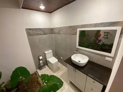 a bathroom with a sink and a fishtank on the wall at Fortuna Jungle & River Retreat - Private pool, River and Wifi in the forest - Secluded, peaceful, truly UNIQUE! A GEM! Book Now! in Guayabal