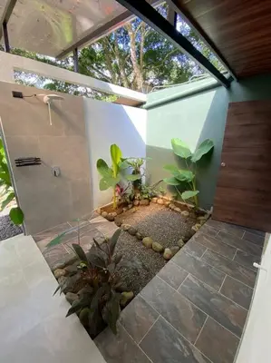 a bathroom with a shower and a garden with plants at Fortuna Jungle & River Retreat - Private pool, River and Wifi in the forest - Secluded, peaceful, truly UNIQUE! A GEM! Book Now! in Guayabal