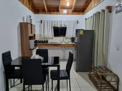 a kitchen with a table and chairs and a refrigerator at Magic Place Monteverde in Monteverde Costa Rica