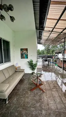a living room with a couch and a table at H et L in Tortuguero