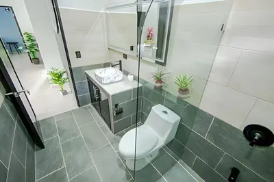 a bathroom with a toilet and a sink at Villa Escondida La Fortuna in Fortuna