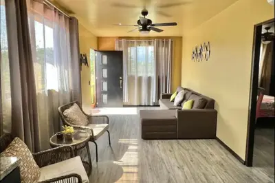 a living room with a couch and a ceiling fan at Villas Confort Completas Manuel Antonio Kepos Costa Ric in Quepos