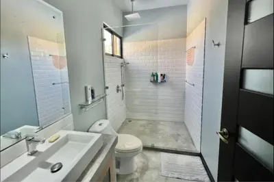 a white bathroom with a sink and a toilet at Villas Confort Completas Manuel Antonio Kepos Costa Ric in Quepos