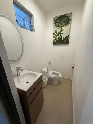 a bathroom with a sink and a toilet and a mirror at Villa Verde 2 Casa 14 in Tamarindo