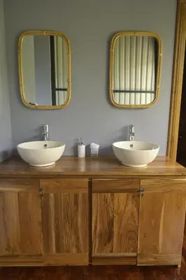 two sinks on a wooden counter with two mirrors at Arenal Hideaway in San Ramón