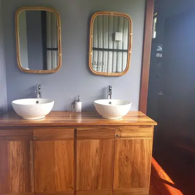 two sinks on a wooden counter with two mirrors at Arenal Hideaway in San Ramón