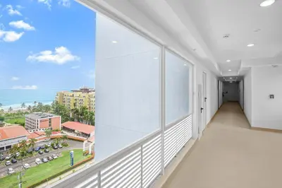 a large window in a building with a view of the ocean at Upstay - New Condo in Jaco - 5 mins from Beach in Jacó