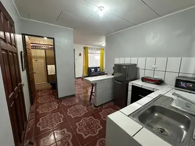 a kitchen with a sink and a refrigerator at Hotel Villa Marsella in Marsella
