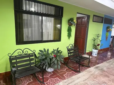 two benches in a room with a green wall at Hotel Villa Marsella in Marsella