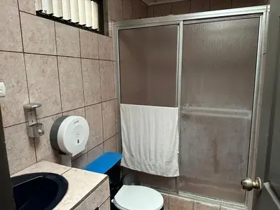 a bathroom with a shower with a toilet and a sink at Hotel Villa Marsella in Marsella