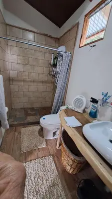 a bathroom with a toilet and a sink at S Natura Birding and Photography in Villa Mills