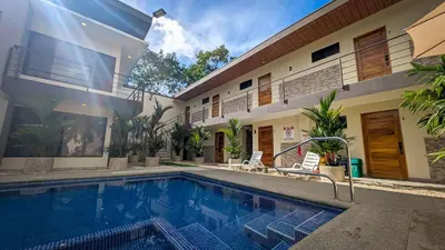 a swimming pool in front of a house at Hotel Uvita Forest in Uvita