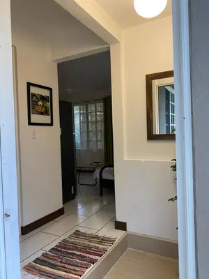 a hallway with a door leading to a living room at Manzu in Santa Cruz