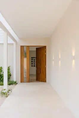 an open hallway with a wooden door and white walls at Secluded Luxury Mansion with Sleek, Modern Design, High-End Amenities, and Spectacular Views in Carpintero
