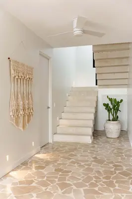 a hallway with stairs and a potted plant at Secluded Luxury Mansion with Sleek, Modern Design, High-End Amenities, and Spectacular Views in Carpintero