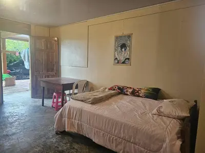 a bedroom with a bed and a table and a table at Departamento Económico, Familiar in San Isidro
