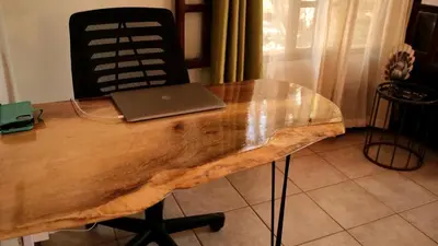 a wooden table with a laptop on top of it at 2bd 2bth Vacation villa in Tamarindo, Costa Rica in Tamarindo