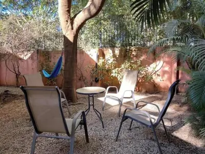 a group of chairs and a table and a tree at 2bd 2bth Vacation villa in Tamarindo, Costa Rica in Tamarindo