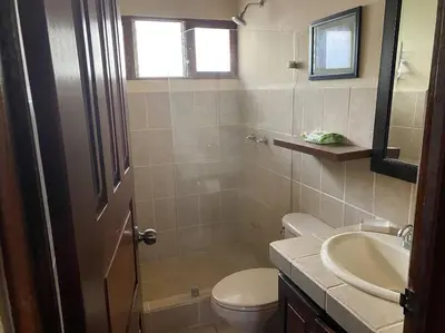 a bathroom with a toilet and a sink at 2bd 2bth Vacation villa in Tamarindo, Costa Rica in Tamarindo