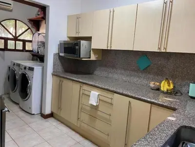 a kitchen with a counter top with a washer and dryer at 2bd 2bth Vacation villa in Tamarindo, Costa Rica in Tamarindo