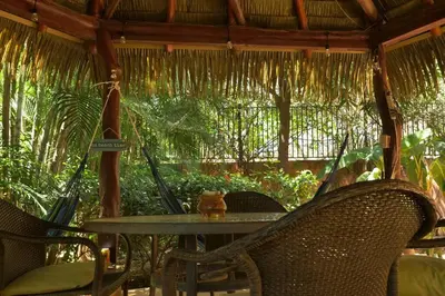 an outdoor table with chairs and a table with a umbrella at 2bd 2bth Vacation villa in Tamarindo, Costa Rica in Tamarindo
