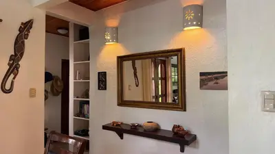 a mirror on a wall with a shelf and lights at 2bd 2bth Vacation villa in Tamarindo, Costa Rica in Tamarindo