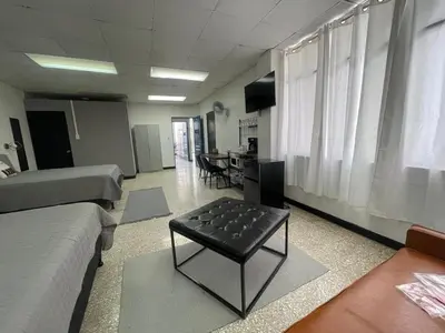 a living room with a couch and a coffee table at San Jose Downtown Suites in San José