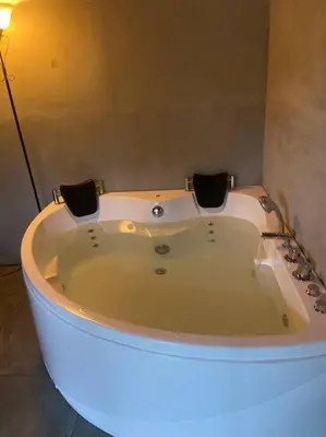 a white bath tub in a room with a light at Chalet Luna y Miel in Dulce Nombre