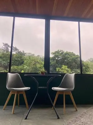 two chairs sitting in front of a window at Chalet Luna y Miel in Dulce Nombre