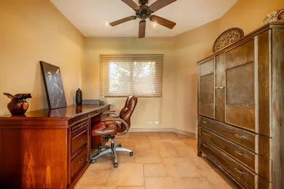 a home office with a desk and a ceiling fan at Casa Shamrock Duplex 1 in Unión