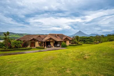 a house with a large yard with a green lawn at Casa Shamrock Duplex 1 in Unión