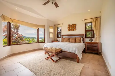 a bedroom with a bed and a large window at Casa Shamrock Duplex 2 in Unión