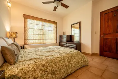 a bedroom with a bed and a window and a television at Casa Shamrock Duplex 2 in Unión
