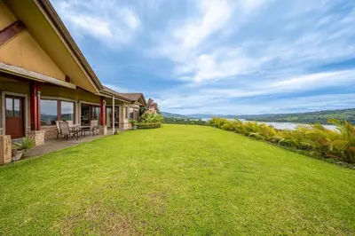 an empty yard next to a house with a large lawn at Casa Shamrock Duplex 2 in Unión