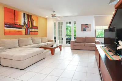 a living room with a couch and a tv at Pacifico TH-104 in Coco