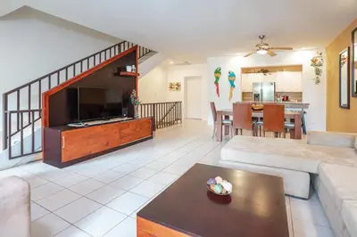 a living room with a large flat screen tv at Pacifico TH-104 in Coco