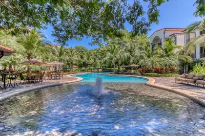 a pool at a resort with a fountain at Pacifico TH-104 in Coco