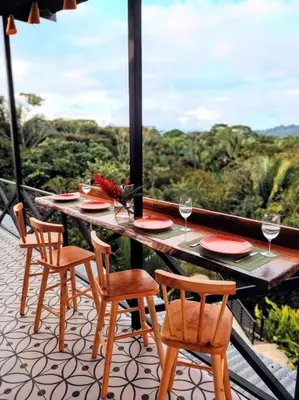a table and chairs on a balcony with a view at CASA TROPICAL-3 bdrm w private pool Close to beach in Esterillos