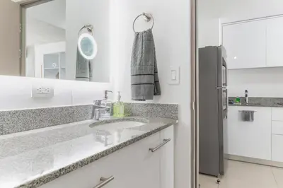 a bathroom with a sink and a mirror at Skyline iFreses, 22nd floor! AC, TV and Pool in Guayabos