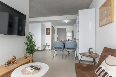 a living room with a couch and a table at Skyline iFreses, 22nd floor! AC, TV and Pool in Guayabos
