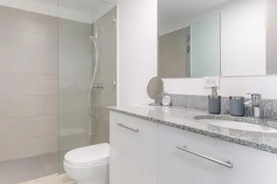 a bathroom with a toilet and a sink and a shower at Cityscape iFreses, 20th floor! AC, TV and Pool in Guayabos